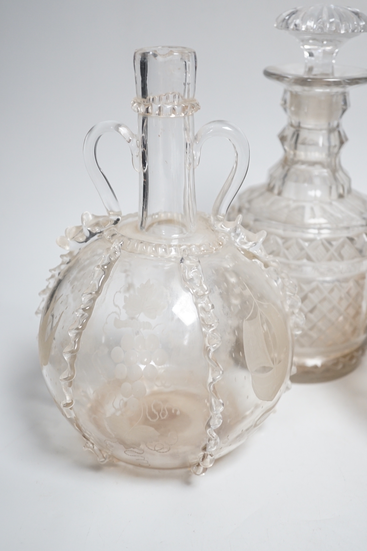 Two Dutch wheel engraved glass flasks and two Regency cut glass decanters, flasks 23cm high (4)